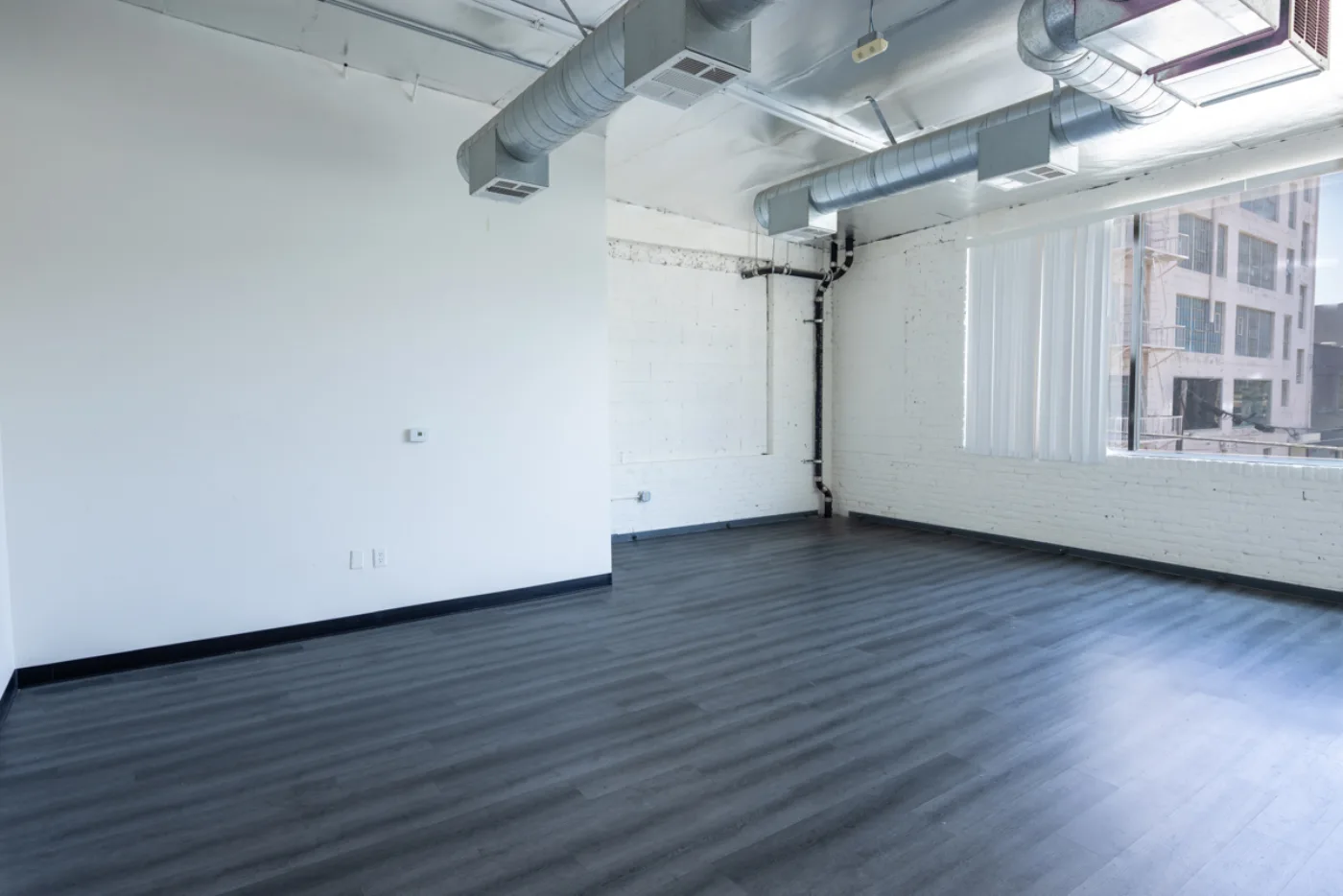 Second-floor suite corner with exposed brick and city view
