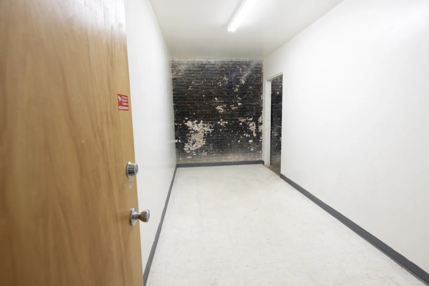 Corridor with exposed brick accent wall