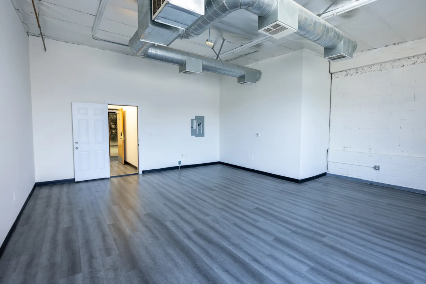 Suite with electrical panel and exposed brick